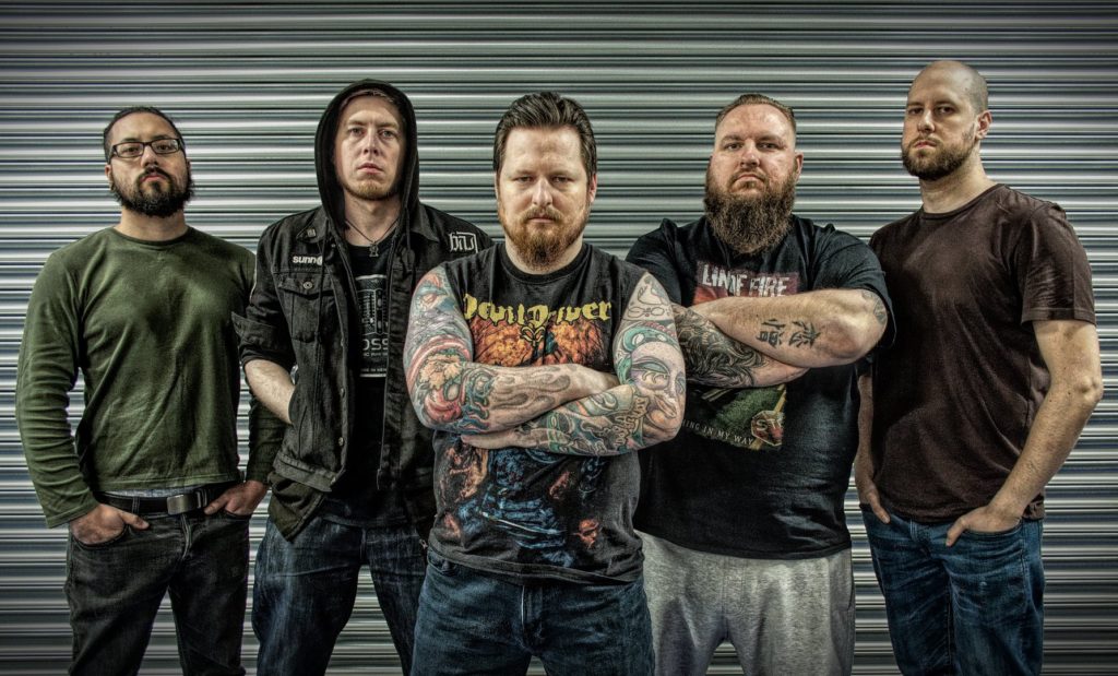 group photo of incinery against a shutter backdrop