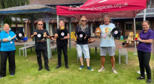 lionheart deliver a cheque to little havens hospice