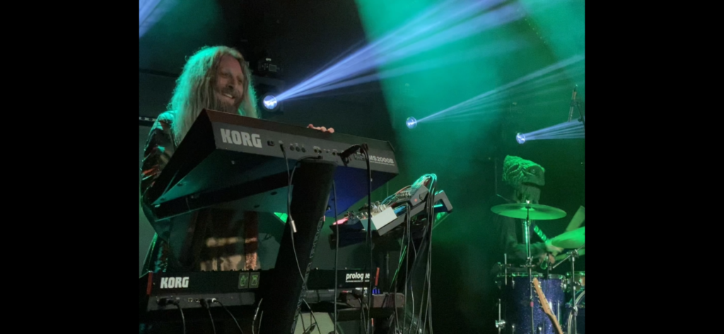 HENGE keyboardist grins from ear to ear with joy in the moment of europhoric music and atmosphere 