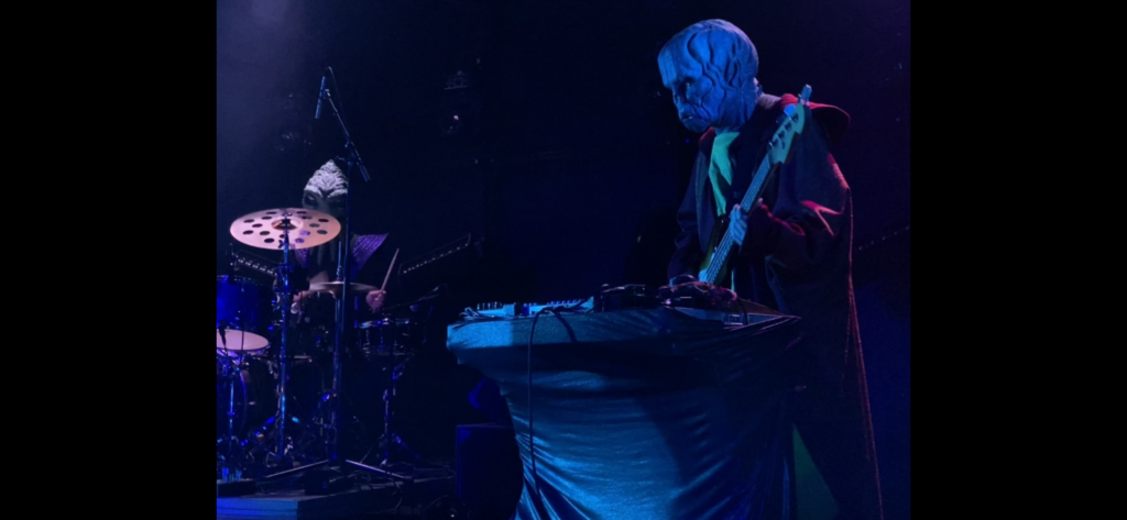 HENGE bassist multi tasking playing bass guitar and keyboard synthesisers 