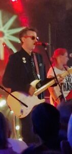 Jim Bob, wearing sunglasses during a gig in Leeds