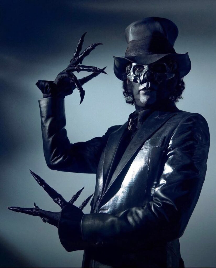Papa V stands in the dark with a white spot light, akin to Edward Scissor Hands.